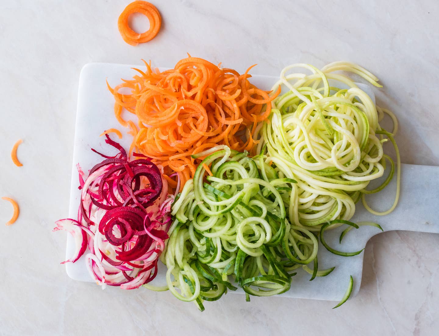 Spiralized Vegetables Noodle Carrot, Beetroot, Zucchini and Cucumber on Marble Board.